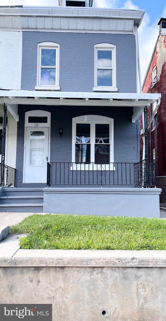 111 Oley St, Reading, PA 19601 - view of front of home with brick siding and a porch