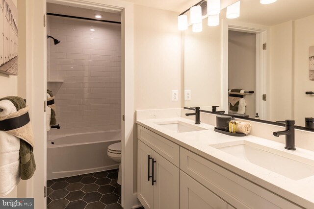 389 Scranton Ln, Ocean View, DE 19970 - bathroom with toilet, tile patterned floors, double vanity, and bathtub / shower combination