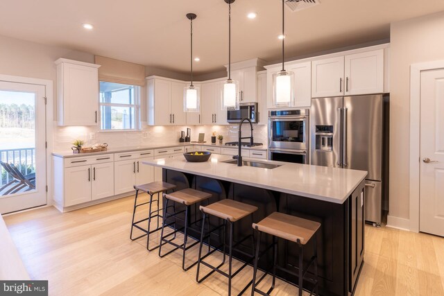 389 Scranton Ln, Ocean View, DE 19970 - kitchen featuring stainless steel appliances, light wood-style flooring, tasteful backsplash, light countertops, and recessed lighting