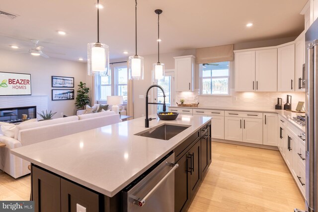 389 Scranton Ln, Ocean View, DE 19970 - kitchen with a sink, open floor plan, stainless steel appliances, light countertops, and white cabinetry