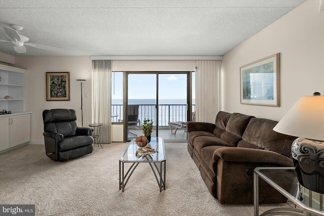 11000 Coastal Hwy Unit 1211, Ocean City, MD 21842 - living room featuring a water view, light colored carpet, ceiling fan, and a textured ceiling