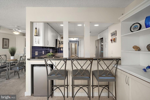 11000 Coastal Hwy Unit 1211, Ocean City, MD 21842 - kitchen with stainless steel appliances, a kitchen breakfast bar, light carpet, open shelves, and recessed lighting