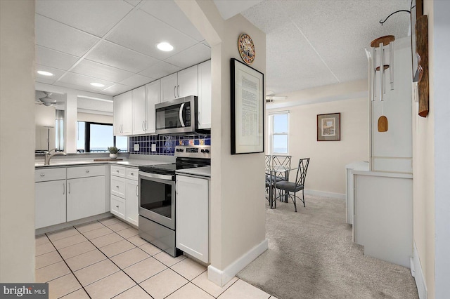 11000 Coastal Hwy Unit 1211, Ocean City, MD 21842 - kitchen featuring stainless steel appliances, white cabinetry, decorative backsplash, recessed lighting, and light carpet