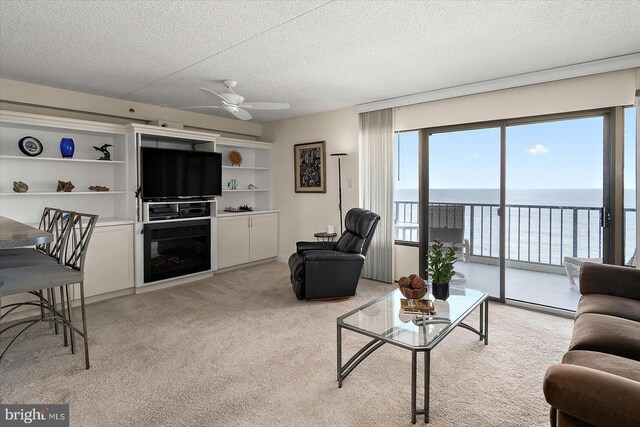 11000 Coastal Hwy Unit 1211, Ocean City, MD 21842 - living area with a ceiling fan, a textured ceiling, and light carpet