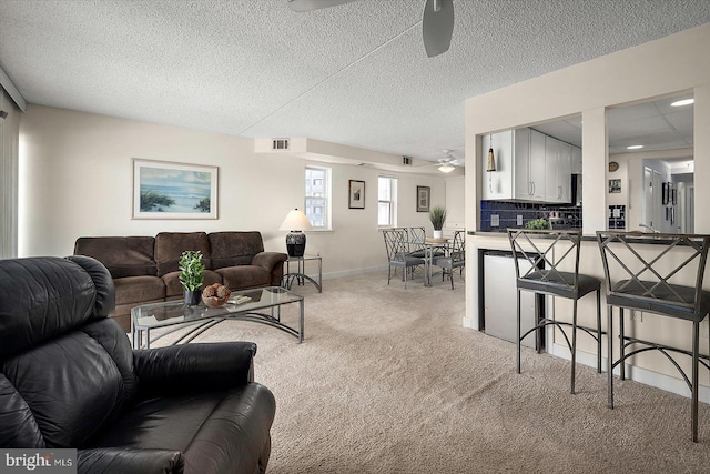 11000 Coastal Hwy Unit 1211, Ocean City, MD 21842 - living room with ceiling fan, light colored carpet, baseboards, and a textured ceiling