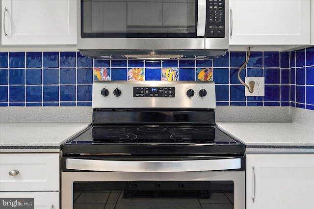 11000 Coastal Hwy Unit 1211, Ocean City, MD 21842 - kitchen featuring appliances with stainless steel finishes, white cabinets, decorative backsplash, and tile patterned flooring