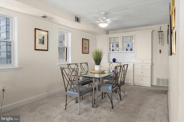 11000 Coastal Hwy Unit 1211, Ocean City, MD 21842 - dining space with a ceiling fan, light colored carpet, baseboards, and a textured ceiling