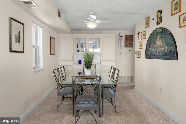 11000 Coastal Hwy Unit 1211, Ocean City, MD 21842 - dining area with ceiling fan, light colored carpet, baseboards, and a textured ceiling