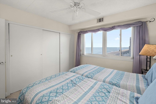 11000 Coastal Hwy Unit 1211, Ocean City, MD 21842 - carpeted bedroom with a closet, multiple windows, a water view, and ceiling fan