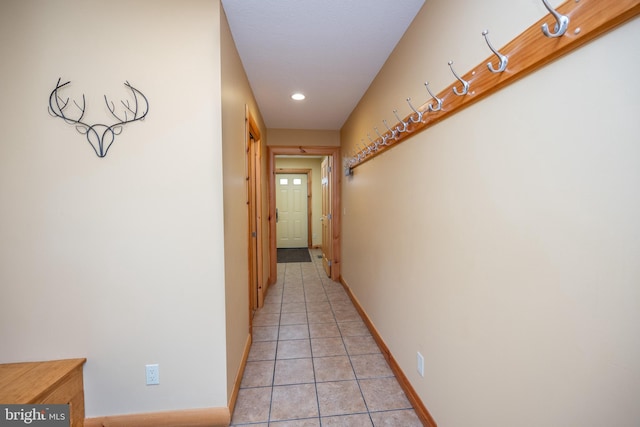 hallway with light tile patterned floors, baseboards, and recessed lighting