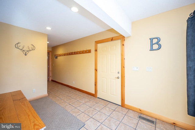 entryway with light tile patterned floors, recessed lighting, and baseboards
