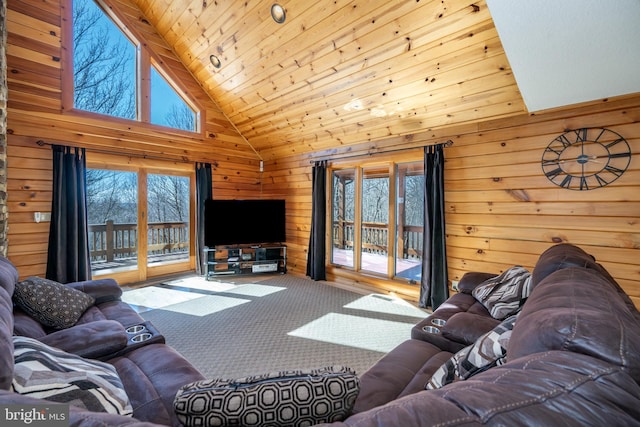 living room with healthy amount of natural light, carpet floors, wooden walls, high vaulted ceiling, and wood ceiling