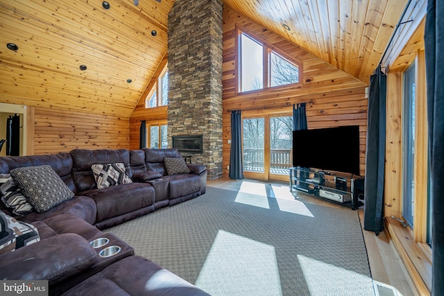 living room featuring wood walls, wooden ceiling, wood finished floors, high vaulted ceiling, and a stone fireplace