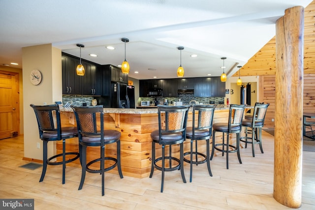 kitchen with black appliances, decorative backsplash, dark cabinetry, recessed lighting, and a peninsula