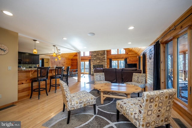 dining area with wooden walls, light wood finished floors, and recessed lighting