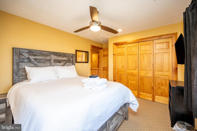 bedroom with light colored carpet, a ceiling fan, a closet, and recessed lighting
