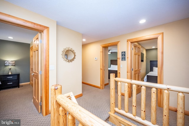 hall featuring carpet, baseboards, and recessed lighting