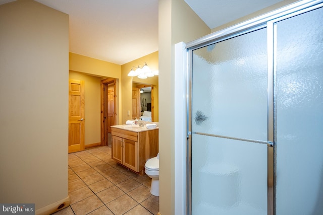 full bathroom with tile patterned flooring, a stall shower, vanity, and baseboards