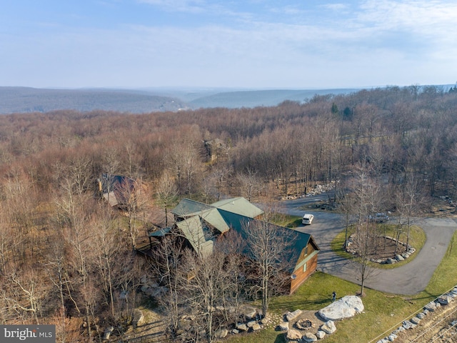 view from above of property featuring a heavily wooded area