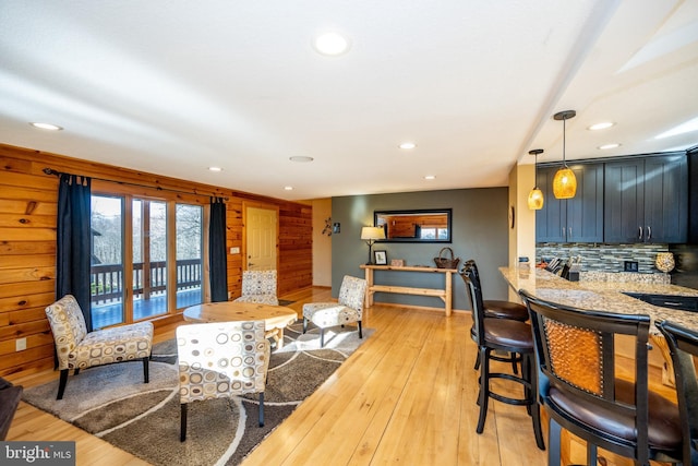 living area with recessed lighting and light wood-style floors