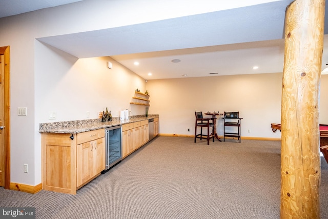 kitchen with wine cooler, light brown cabinetry, light carpet, baseboards, and recessed lighting