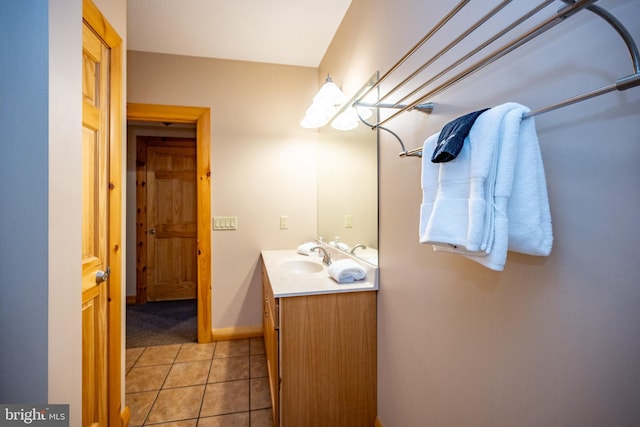 bathroom featuring vanity, tile patterned flooring, and baseboards