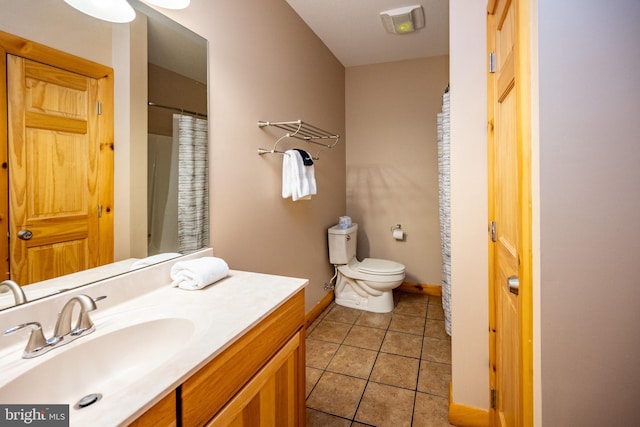 full bath featuring tile patterned floors, toilet, vanity, and baseboards