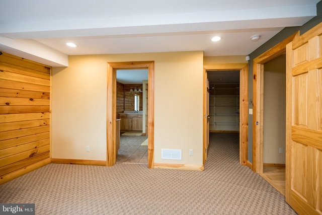 unfurnished bedroom with a spacious closet, a closet, carpet flooring, baseboards, and recessed lighting
