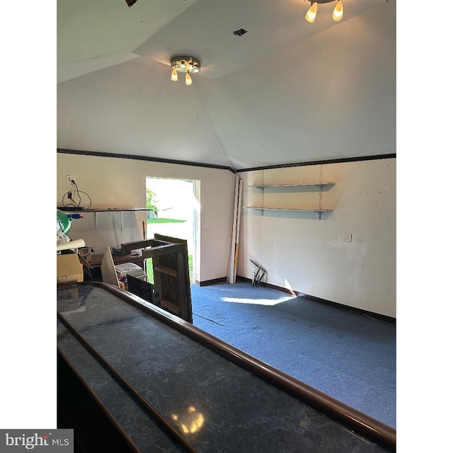 workout room with lofted ceiling and baseboards