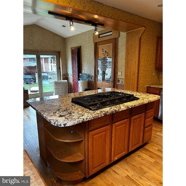 kitchen with black gas stovetop, wallpapered walls, vaulted ceiling, light wood-style flooring, and open shelves