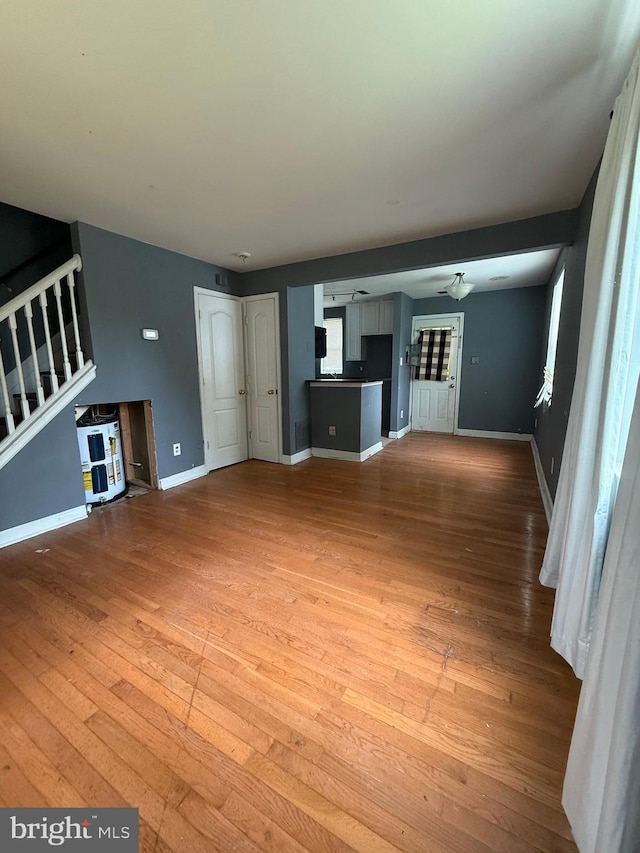 2503 Kent Town Pl Unit 2503B, Hyattsville, MD 20785 - unfurnished living room featuring hardwood / wood-style floors, stairs, and baseboards