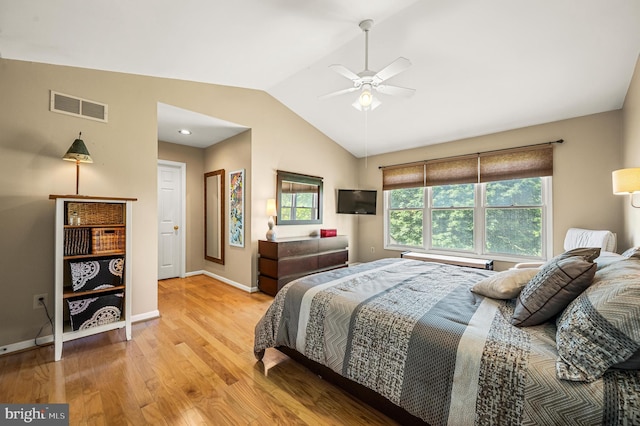 bedroom featuring vaulted ceiling, wood finished floors, baseboards, and ceiling fan