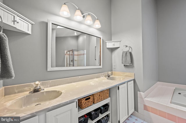 full bathroom with a shower stall, double vanity, and a garden tub