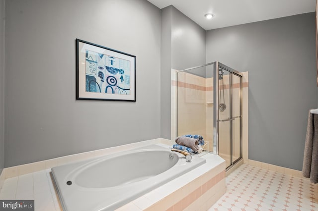 full bathroom with a stall shower and a bath