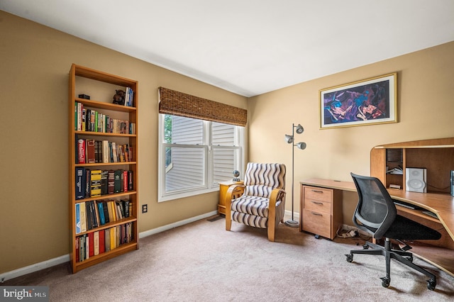 carpeted home office featuring baseboards