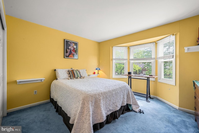 carpeted bedroom featuring baseboards
