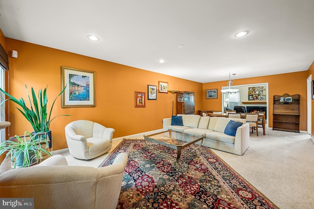 carpeted living area with baseboards and recessed lighting