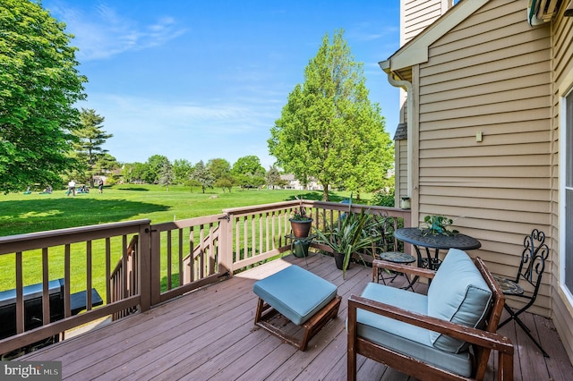 wooden terrace featuring a lawn
