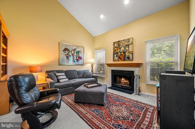 carpeted living area featuring a fireplace with flush hearth, recessed lighting, and high vaulted ceiling