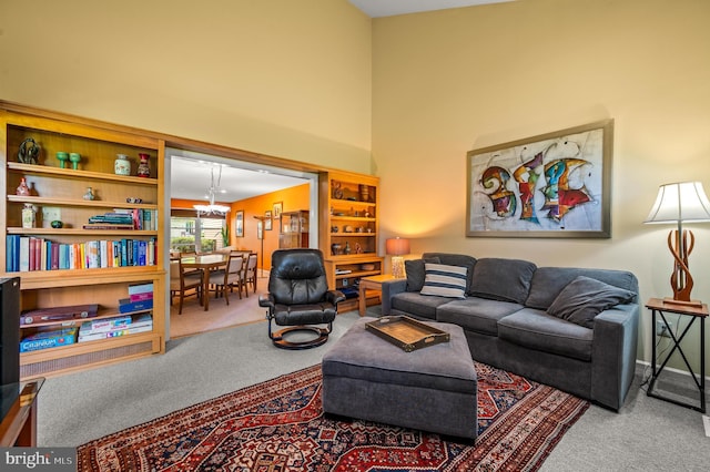 living room featuring carpet flooring, a high ceiling, and baseboards