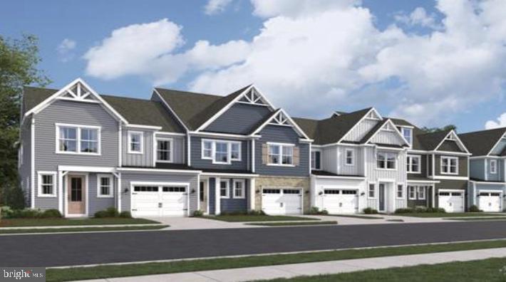 view of front of property with an attached garage, a residential view, and driveway