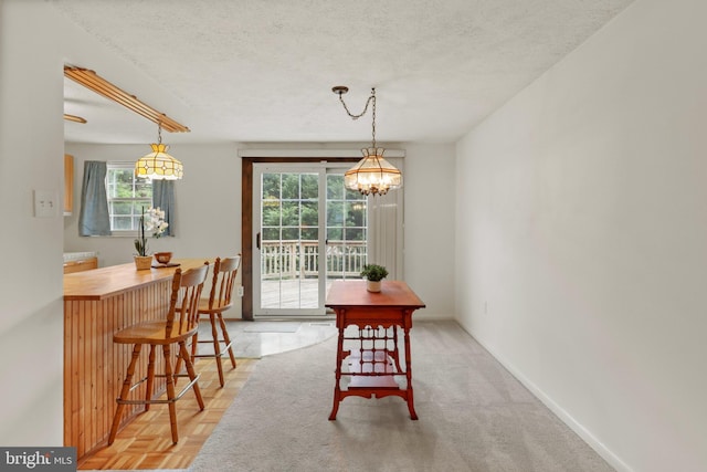9269 Pigeonwing Pl, Columbia, MD 21045 - dining room with a chandelier, a textured ceiling, and baseboards