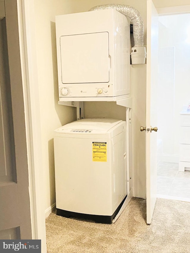 5802 Torington Dr Unit H, Springfield, VA 22152 - clothes washing area featuring estacked washer and dryer, light carpet, and baseboards