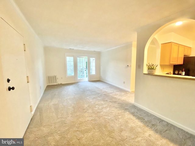 5802 Torington Dr Unit H, Springfield, VA 22152 - unfurnished living room with light carpet, baseboards, and arched walkways