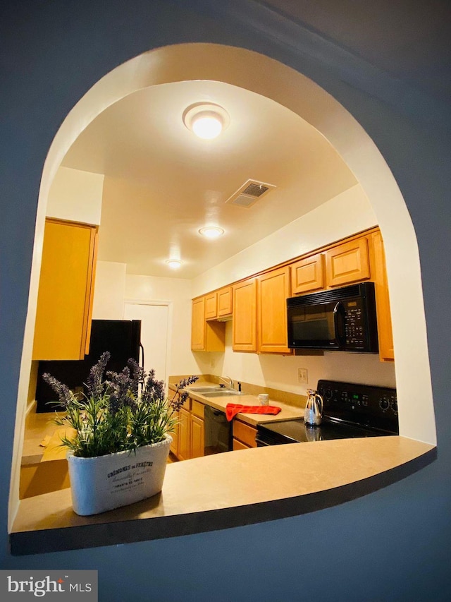 5802 Torington Dr Unit H, Springfield, VA 22152 - kitchen featuring black appliances, arched walkways, and a sink