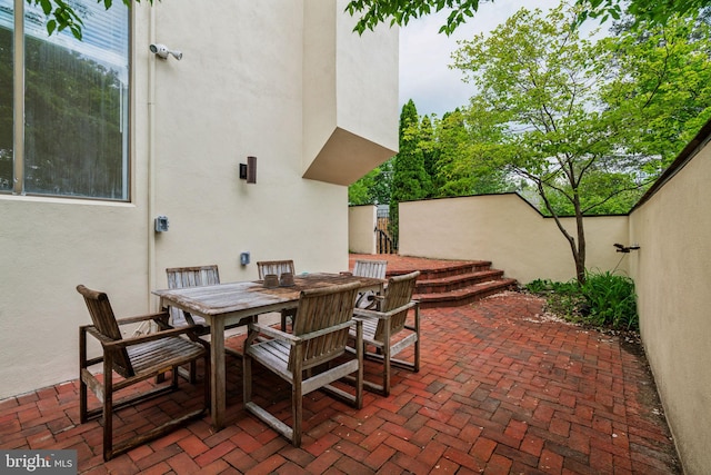 view of patio / terrace with outdoor dining space and fence