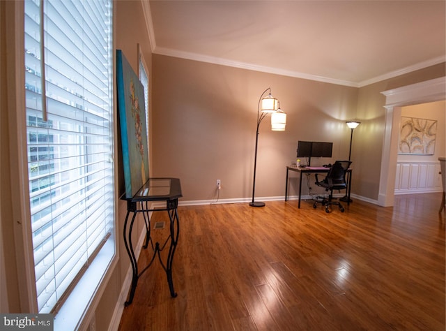 home office with wood finished floors, ornamental molding, and baseboards