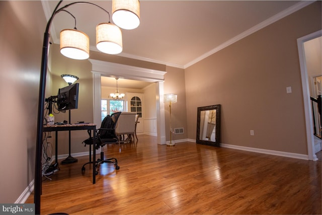 dining area with ornamental molding, a chandelier, wood finished floors, and baseboards