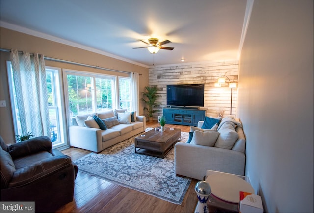 living area featuring a ceiling fan, wood finished floors, and ornamental molding