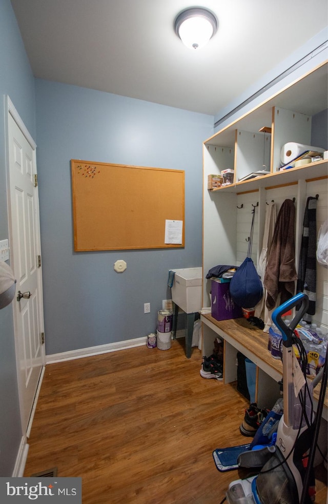 mudroom with wood finished floors and baseboards